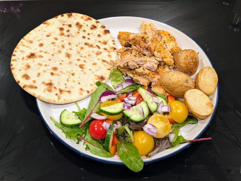 chicken gyros, salad, potatoes and flat bread